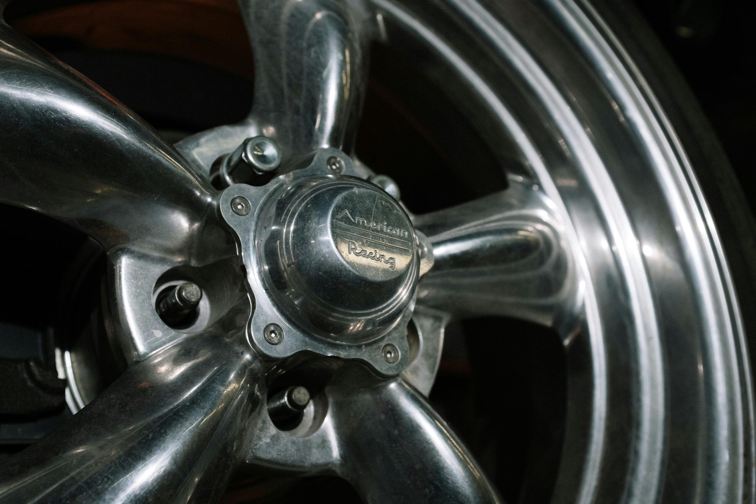 Close-up view of a chrome wheel from an American Racing car. Ideal for auto and mechanical industry visuals.